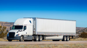 Atlanta Truck Accident Lawyer - Eighteen wheel big rig tractor with trailer on highway. Trucking industry